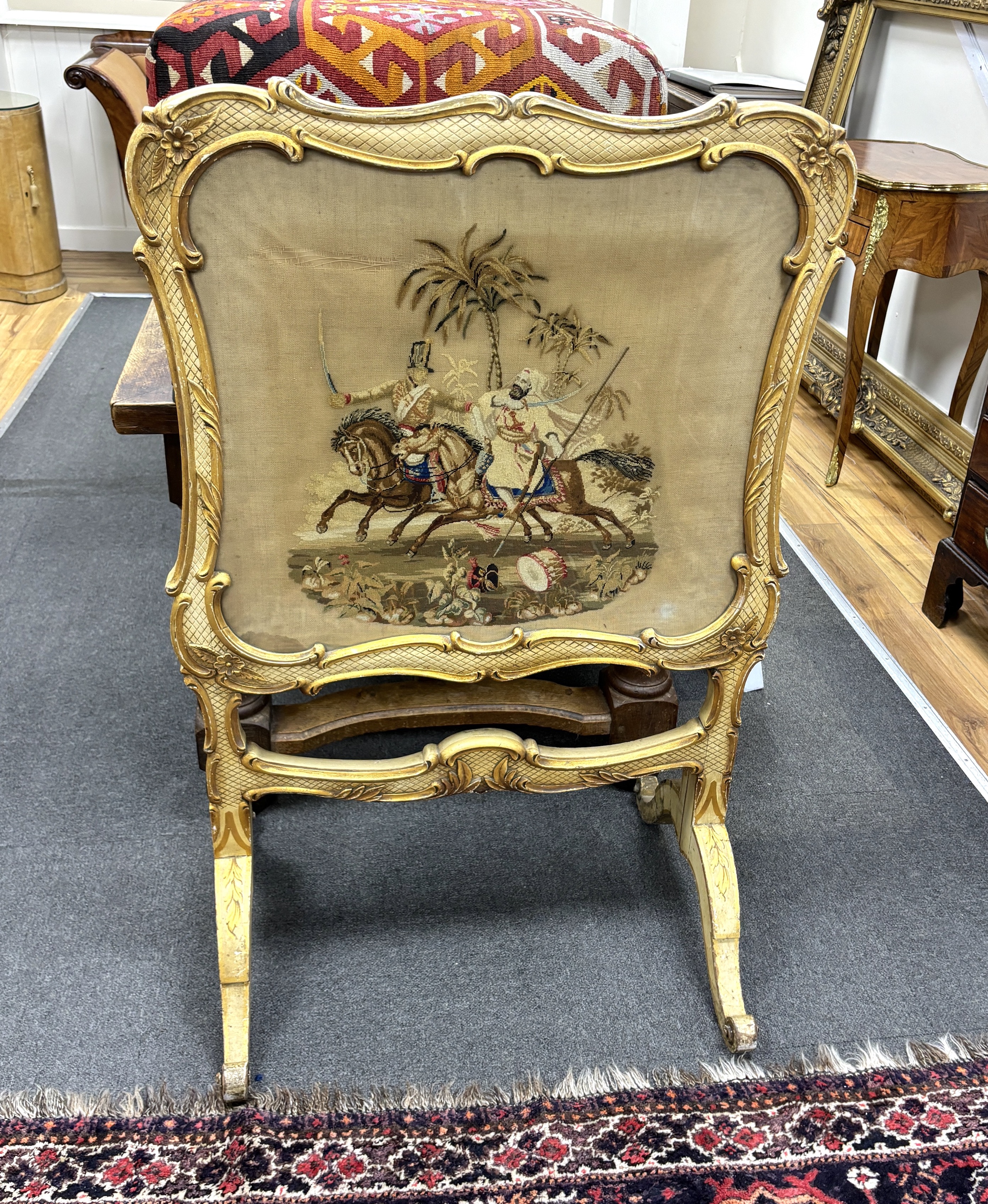 A Victorian cream painted firescreen with tapestry banner, width 74cm, height 115cm. Condition - fair